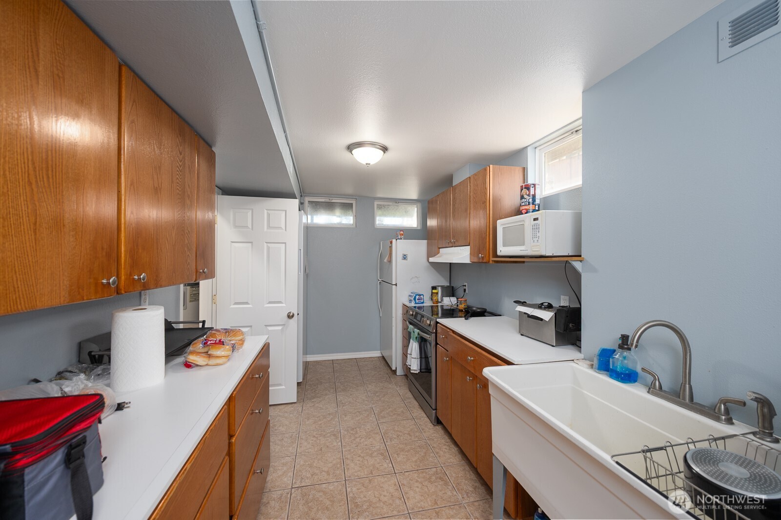 11627 Rd K Northeast Moses Lake, WA 98837 - Photo 26 of 37 a kitchen with a sink stove and cabinets