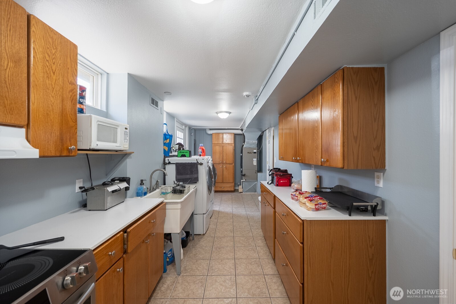11627 Rd K Northeast Moses Lake, WA 98837 - Photo 27 of 37 a kitchen with stainless steel appliances a sink stove and cabinets