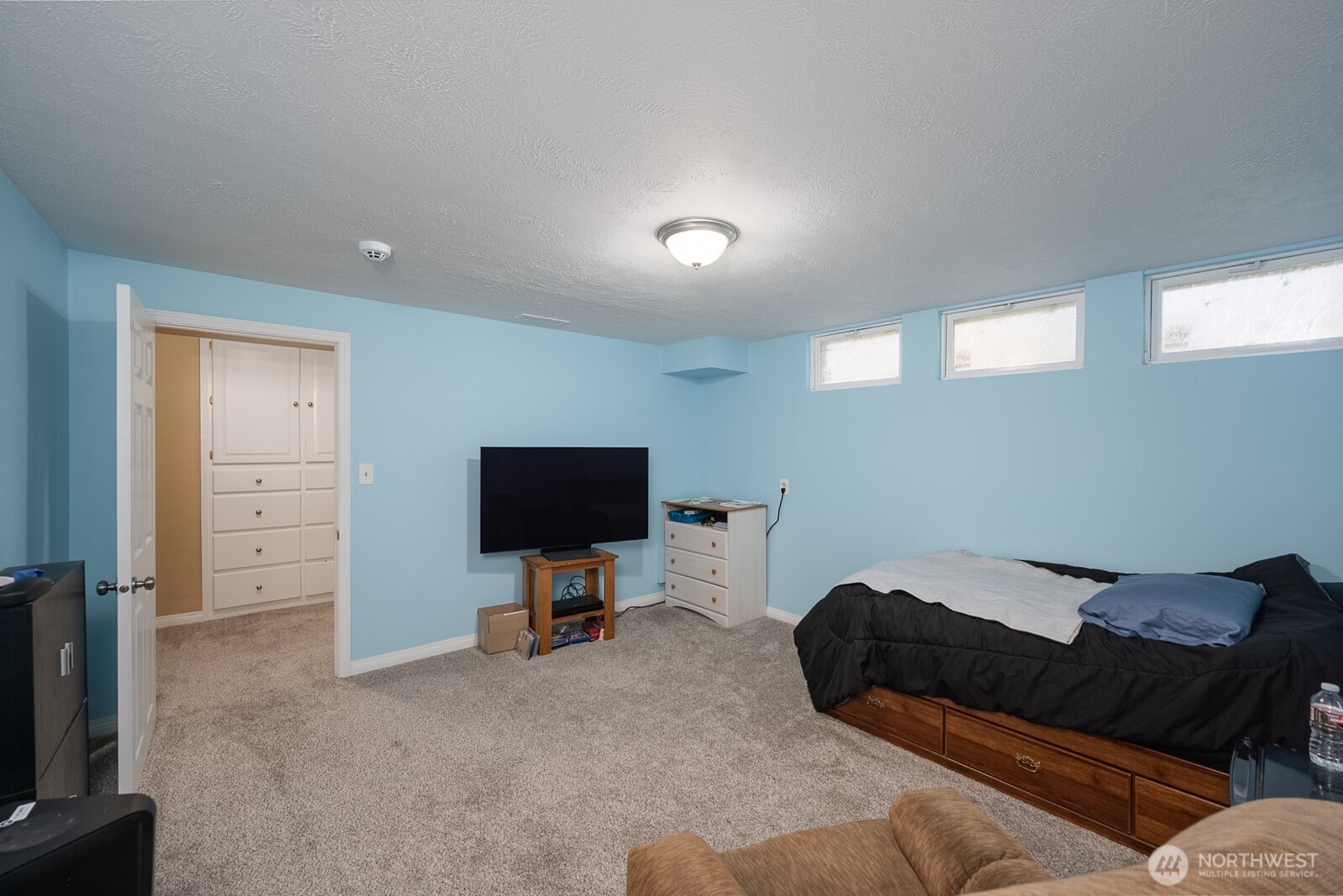 11627 Rd K Northeast Moses Lake, WA 98837 - Photo 28 of 37 a bedroom with furniture and a flat screen tv
