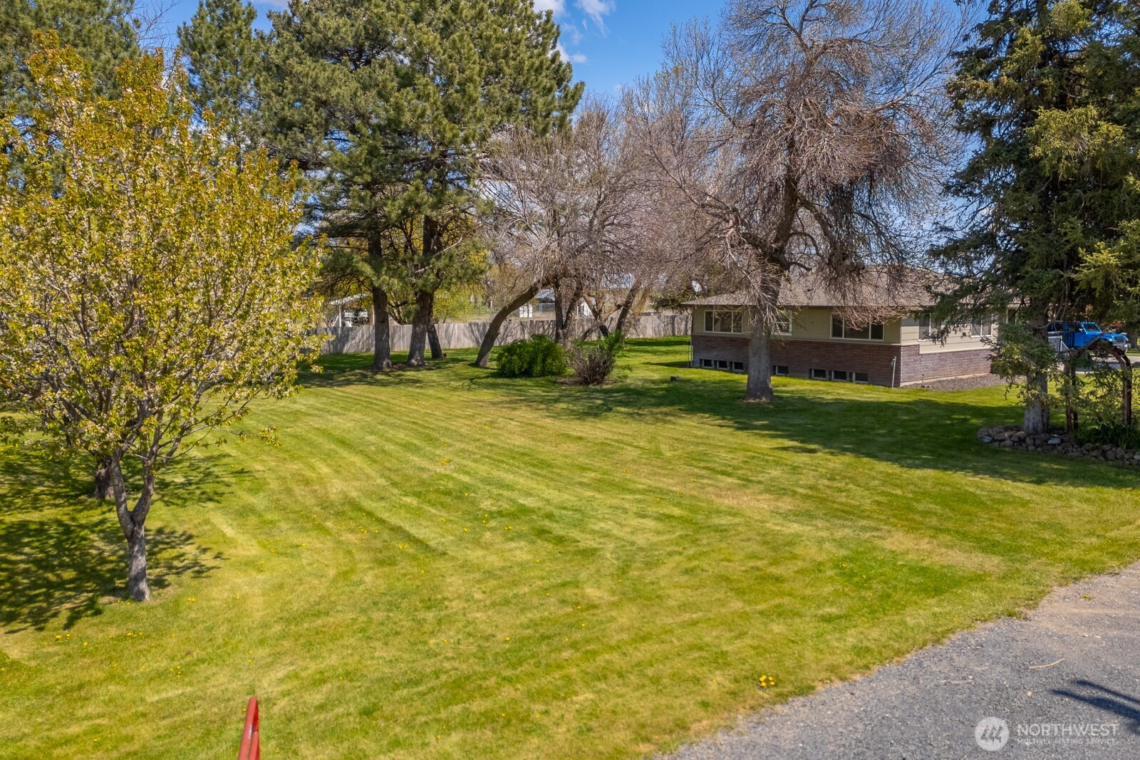 11627 Rd K Northeast Moses Lake, WA 98837 - Photo 34 of 37 a view of a swimming pool with a bench and trees