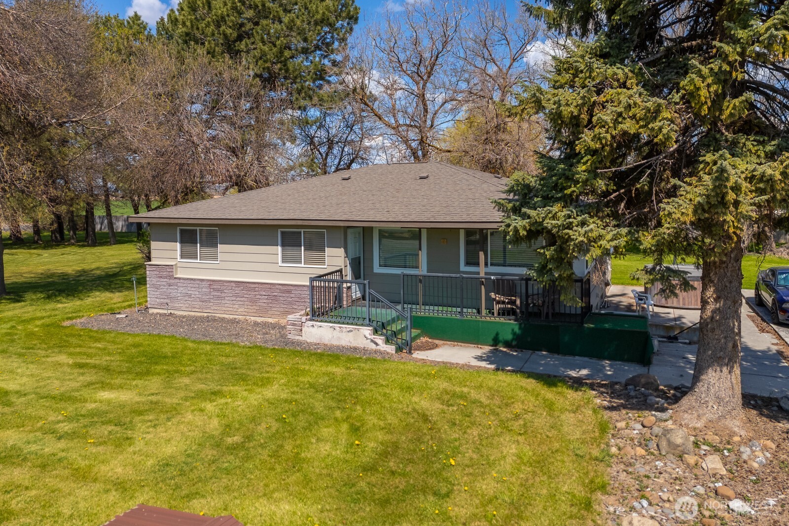 11627 Rd K Northeast Moses Lake, WA 98837 - Photo 4 of 37 a front view of a house with a yard garage and outdoor seating