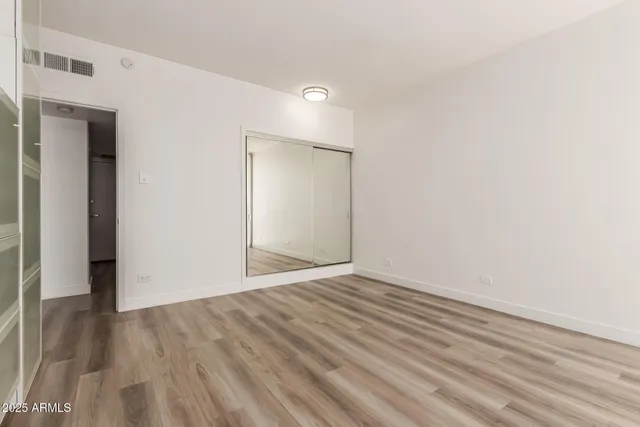 a view of an empty room with wooden floor