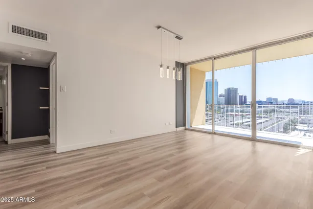 wooden floor chandelier and windows in a room