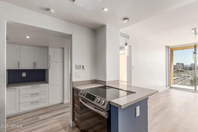 a kitchen with granite countertop a sink and a stove top oven