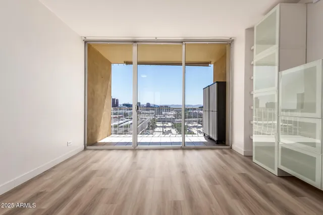 an empty room with wooden floor and a window