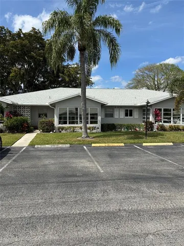 a view of a white house with a swimming pool