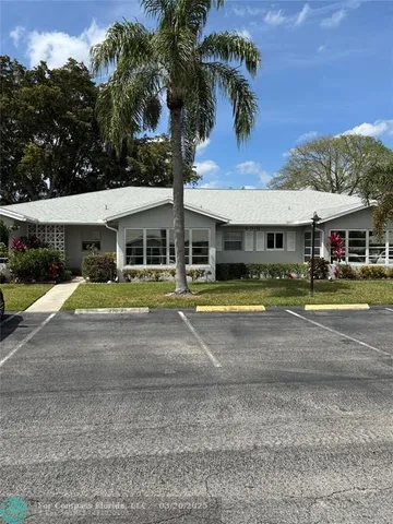 a view of a white house with a swimming pool