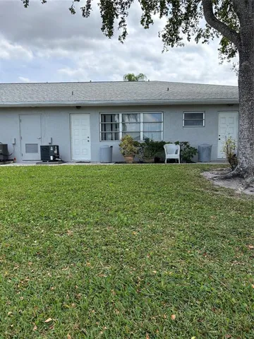 a view of a house with a backyard