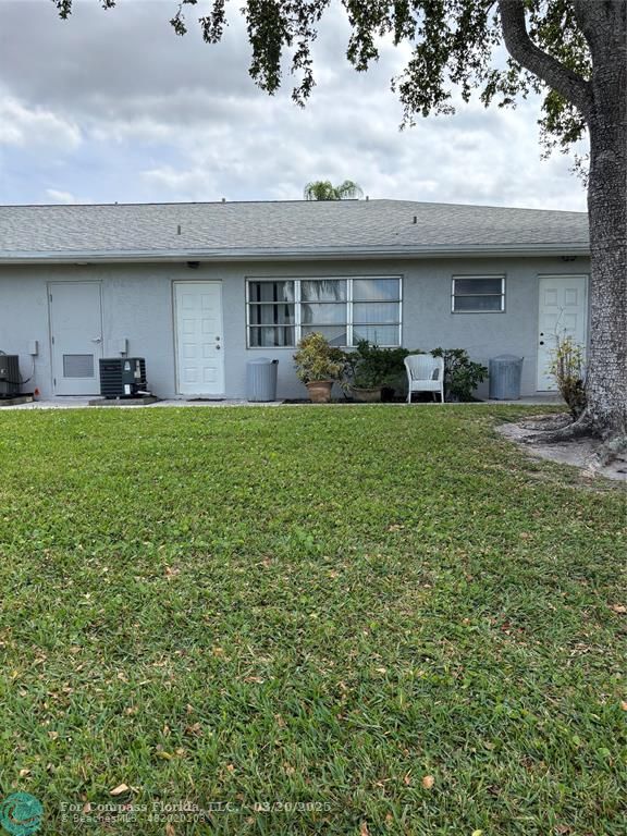 14748 Canalview Drive, Unit B Delray Beach, FL 33484 - Photo 11 of 12 a view of a house with a backyard