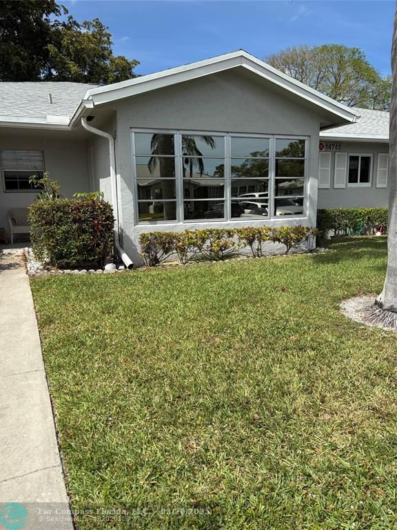 14748 Canalview Drive, Unit B Delray Beach, FL 33484 - Photo 3 of 12 a house with trees in the background