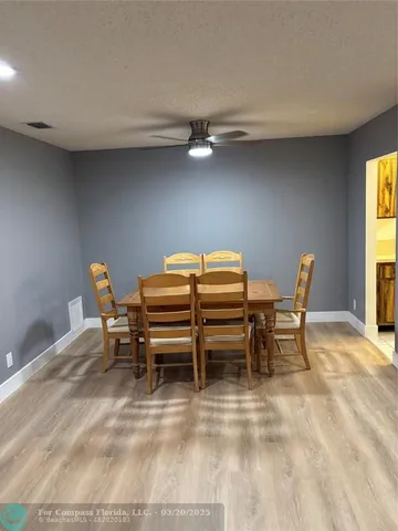 a view of a dining room with furniture and a window