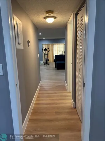 a view of gallery with wooden floor