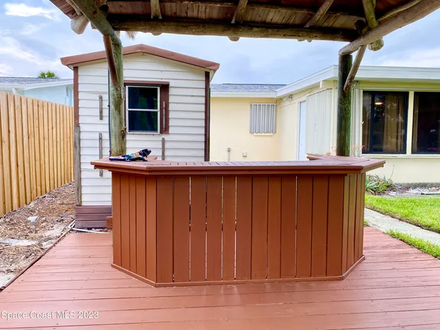 a view of a house with wooden deck