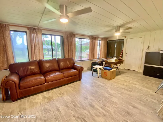 a living room with furniture window and a table