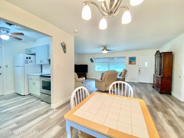 a living room with furniture a flat screen tv and a table