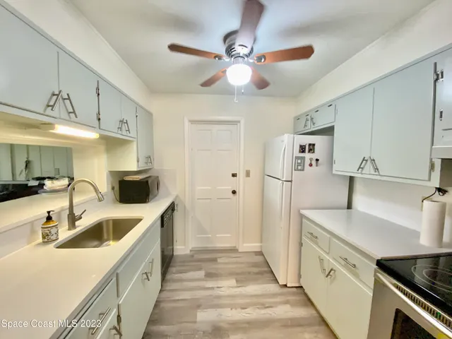 a kitchen with a sink and a refrigerator