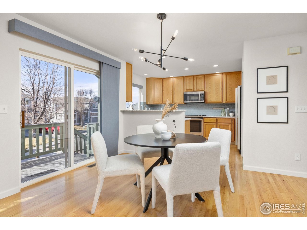 6644 Drew Ranch Lane Boulder, CO 80301 - Photo 11 of 45 a dining room with furniture a chandelier and wooden floor