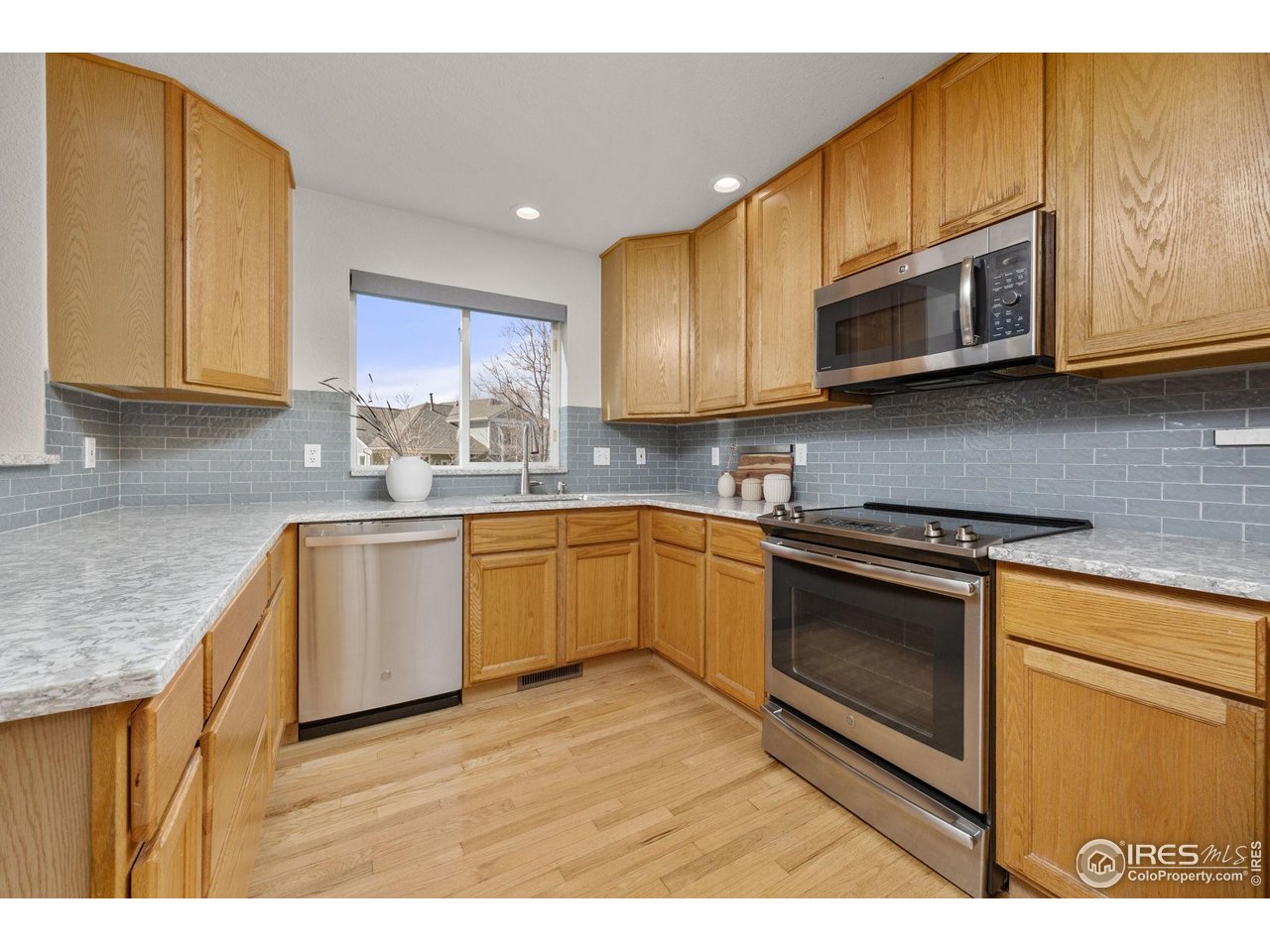 6644 Drew Ranch Lane Boulder, CO 80301 - Photo 12 of 45 a kitchen with stainless steel appliances granite countertop a sink a stove a microwave and cabinets