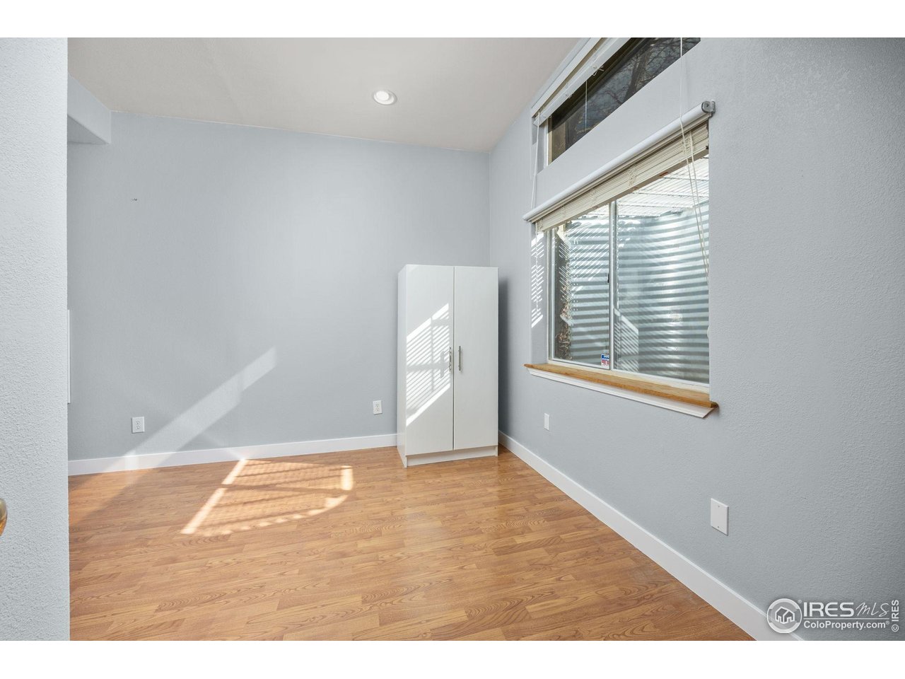 6644 Drew Ranch Lane Boulder, CO 80301 - Photo 28 of 45 a view of an empty room with wooden floor and a window