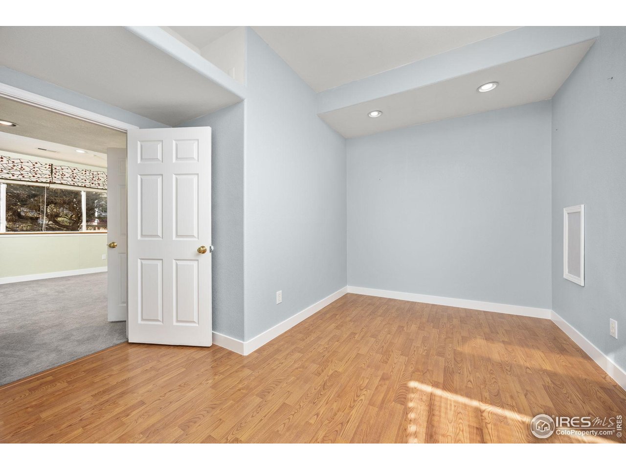 6644 Drew Ranch Lane Boulder, CO 80301 - Photo 29 of 45 an empty room with wooden floor and windows
