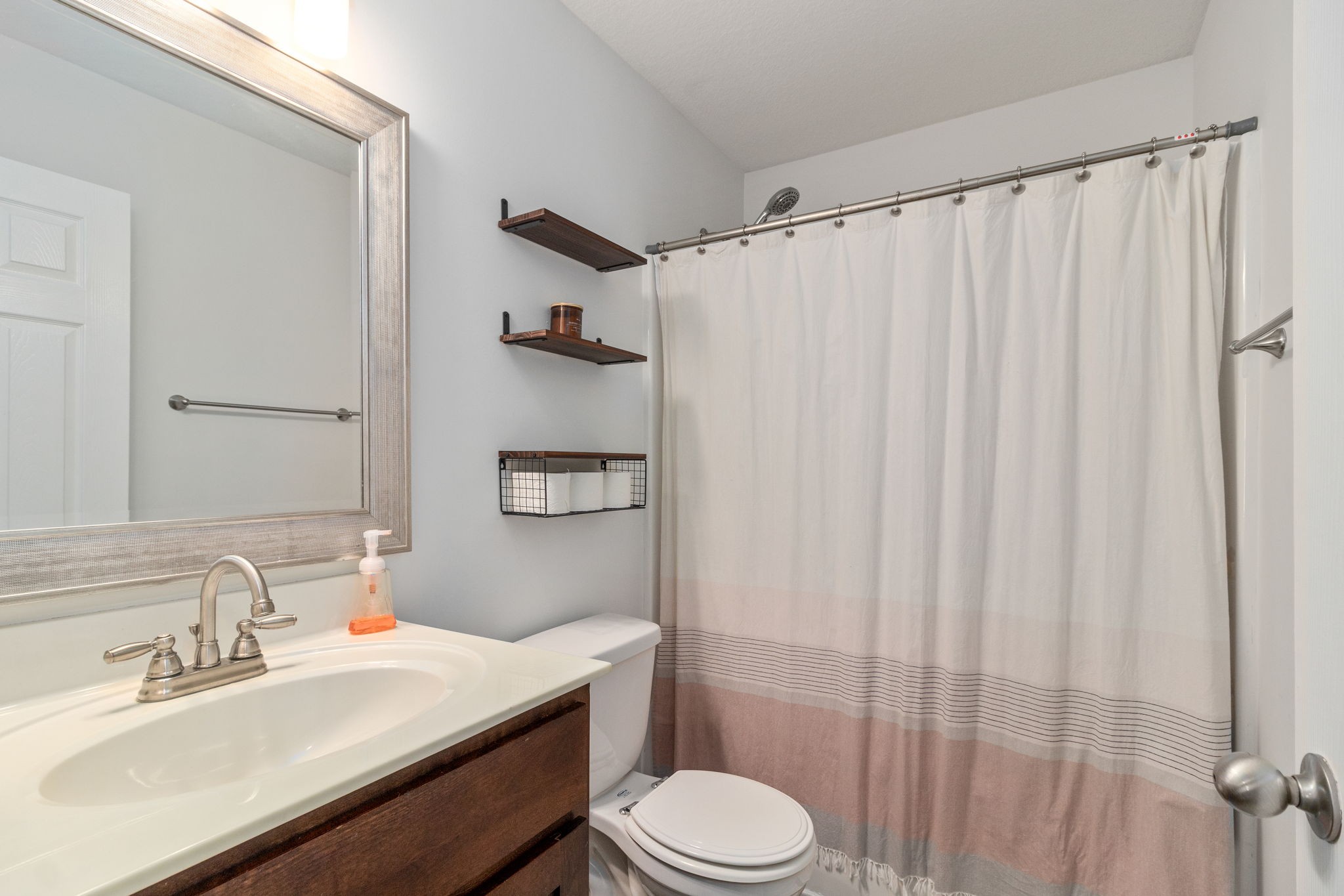 949 Hugh Hunter Road Oak Grove, KY 42262 - Photo 14 of 21 a bathroom with a sink a toilet a mirror and shower curtain