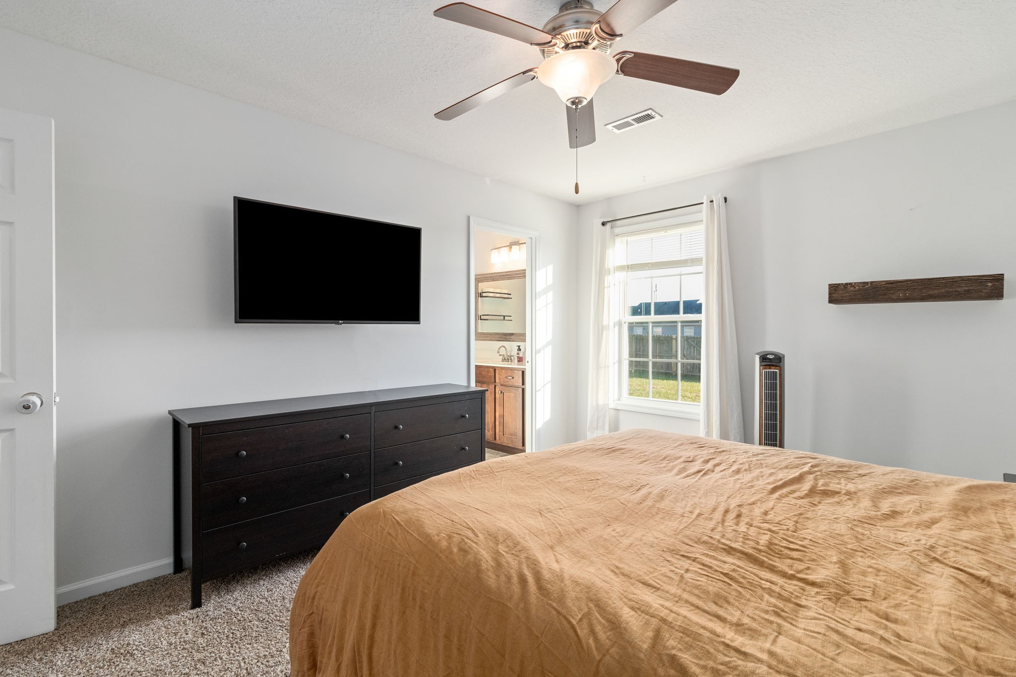 949 Hugh Hunter Road Oak Grove, KY 42262 - Photo 18 of 21 a bedroom with a bed and a flat screen tv