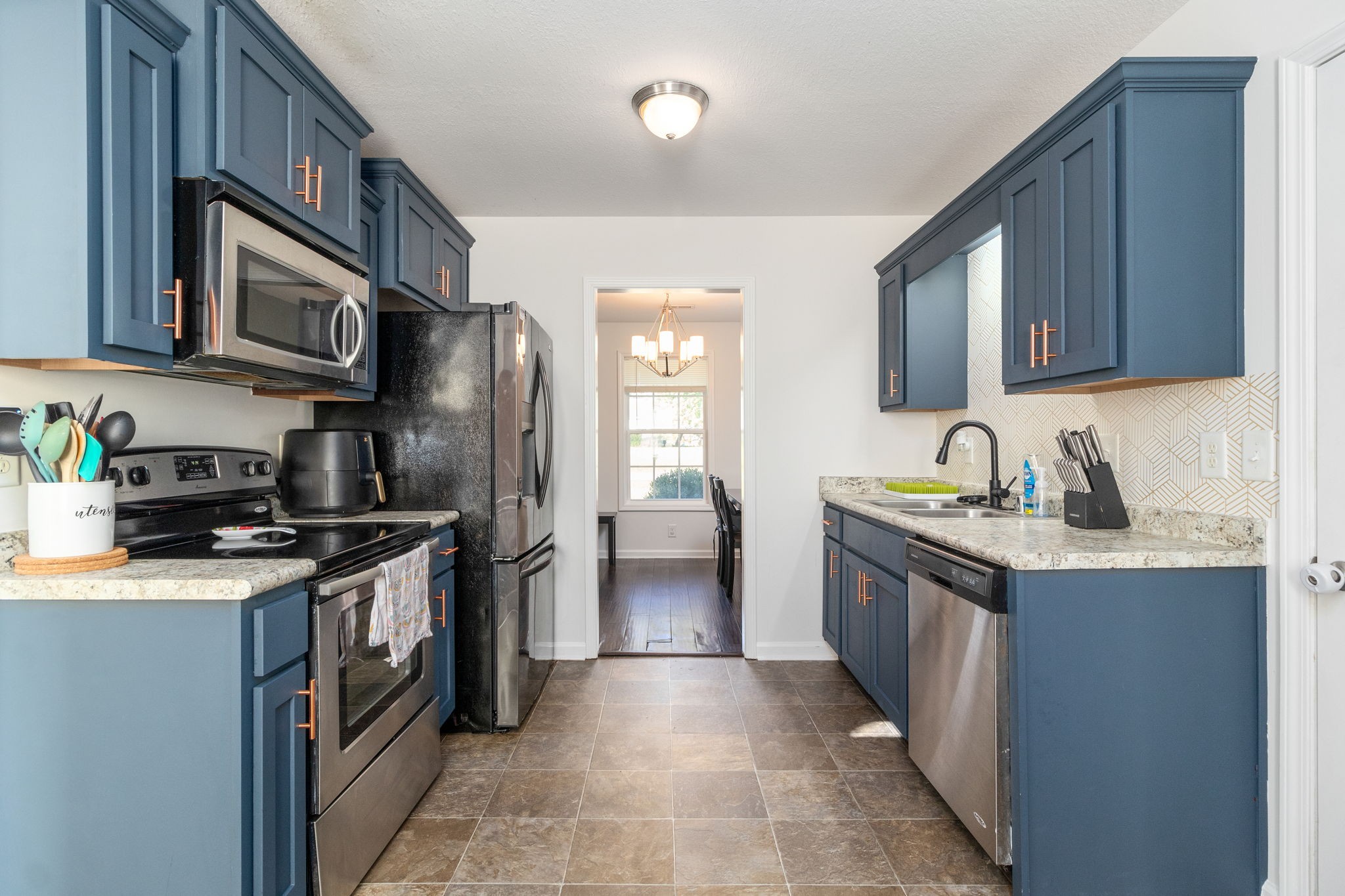 949 Hugh Hunter Road Oak Grove, KY 42262 - Photo 8 of 21 a kitchen with stainless steel appliances granite countertop a sink stove and refrigerator