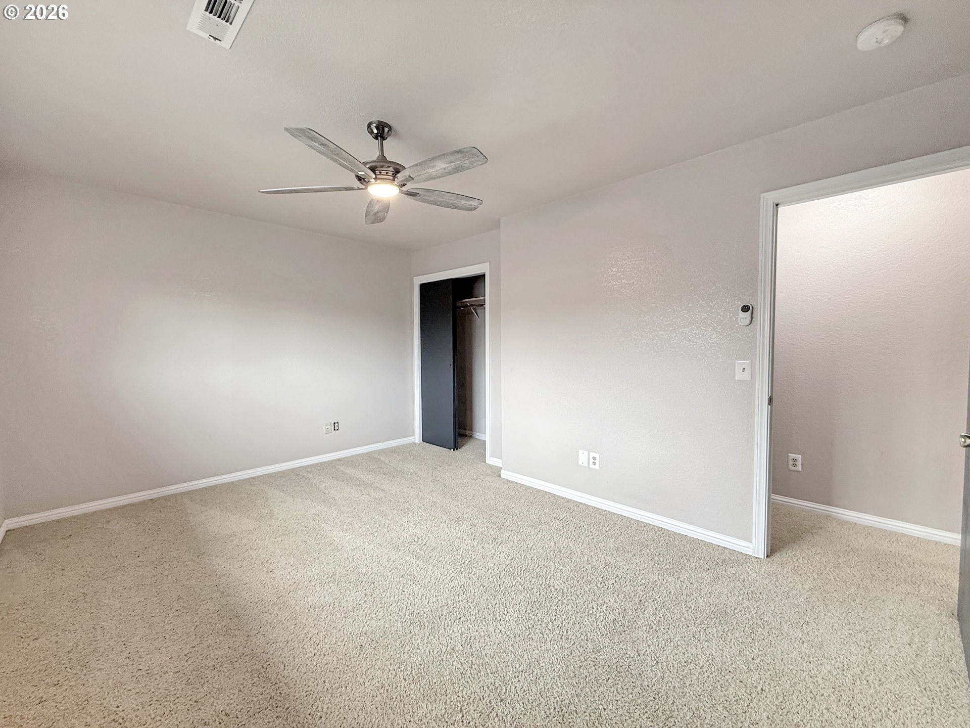 325 Matot Street, Unit B Brookings, OR 97415 - Photo 14 of 28 an empty room with a chandelier fan and windows