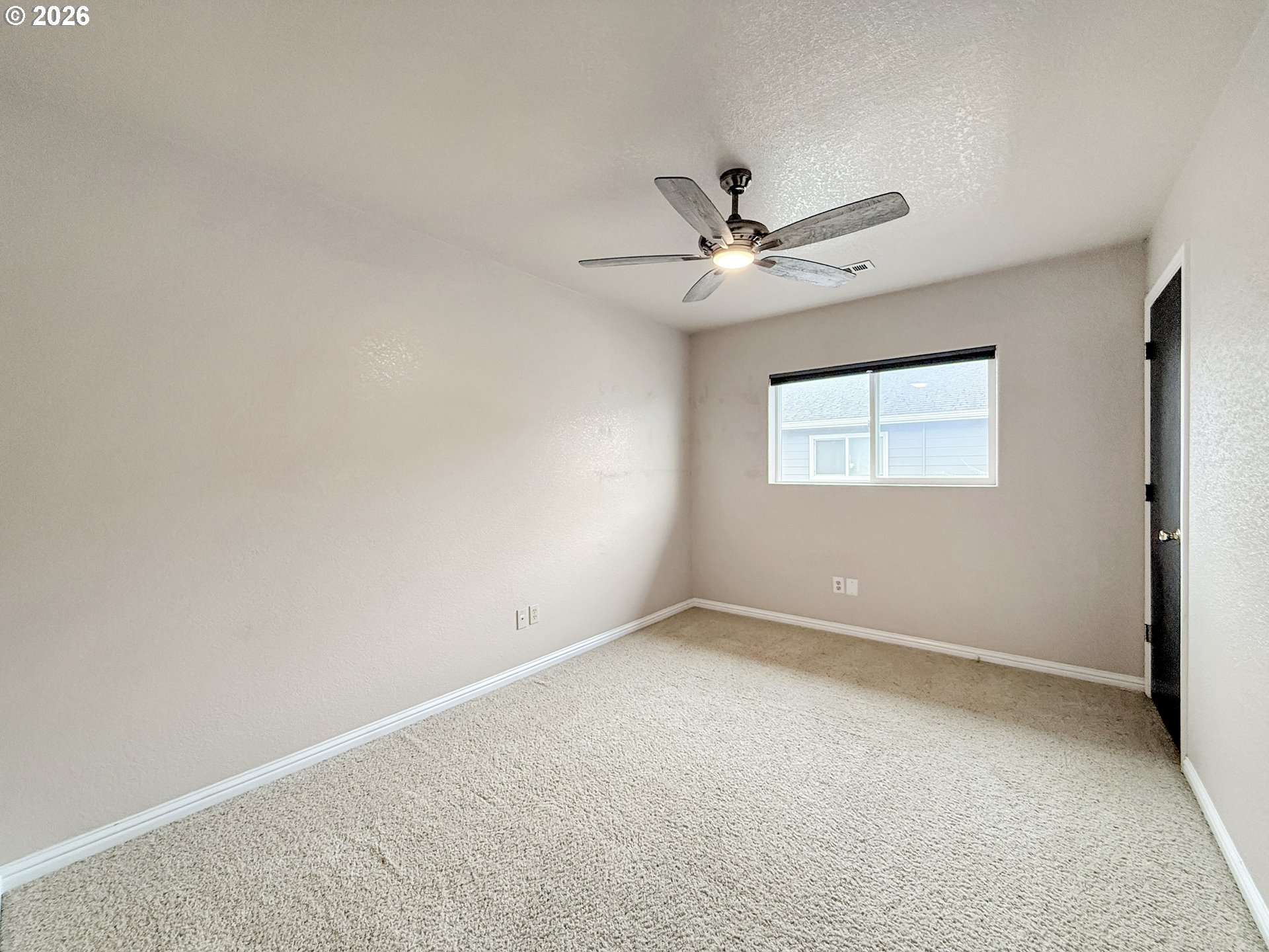325 Matot Street, Unit B Brookings, OR 97415 - Photo 18 of 28 an empty room with a window and a fan