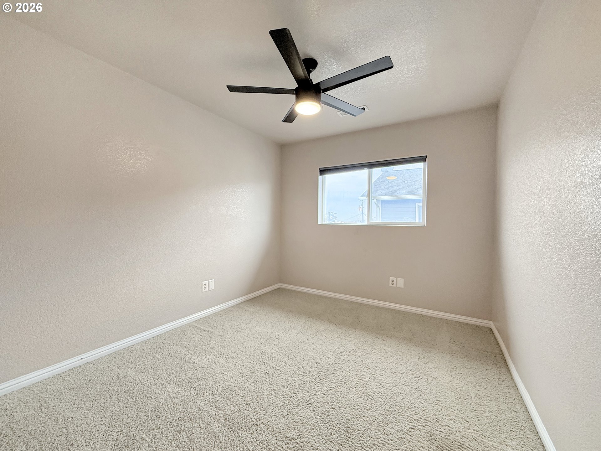 325 Matot Street, Unit B Brookings, OR 97415 - Photo 21 of 28 an empty room with a window and a fan