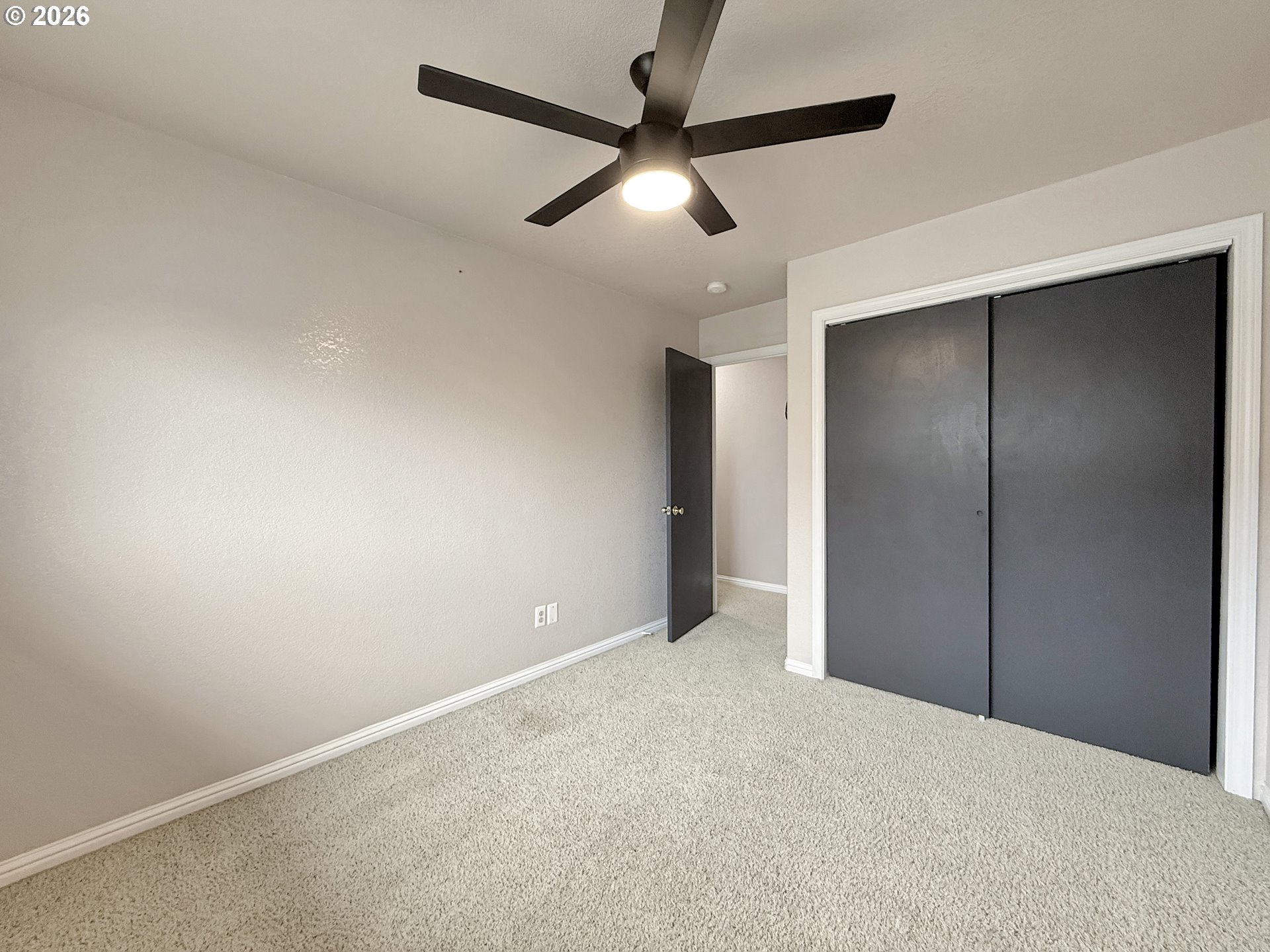 325 Matot Street, Unit B Brookings, OR 97415 - Photo 22 of 28 an empty room with chandelier fan