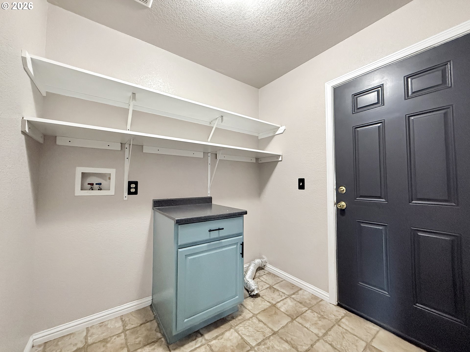325 Matot Street, Unit B Brookings, OR 97415 - Photo 23 of 28 a room with cabinets and wooden floor