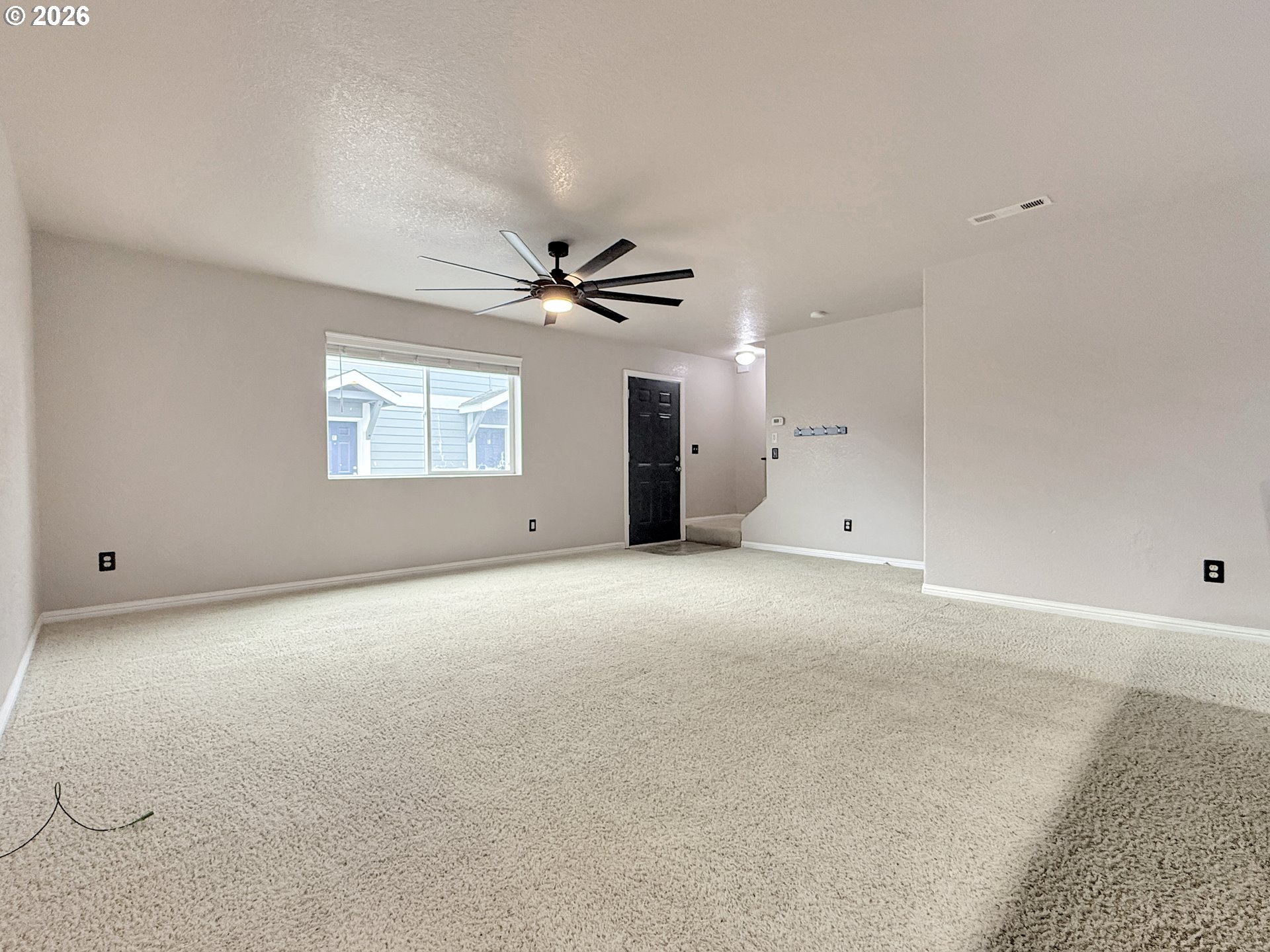 325 Matot Street, Unit B Brookings, OR 97415 - Photo 6 of 28 an empty room with a ceiling fan and window