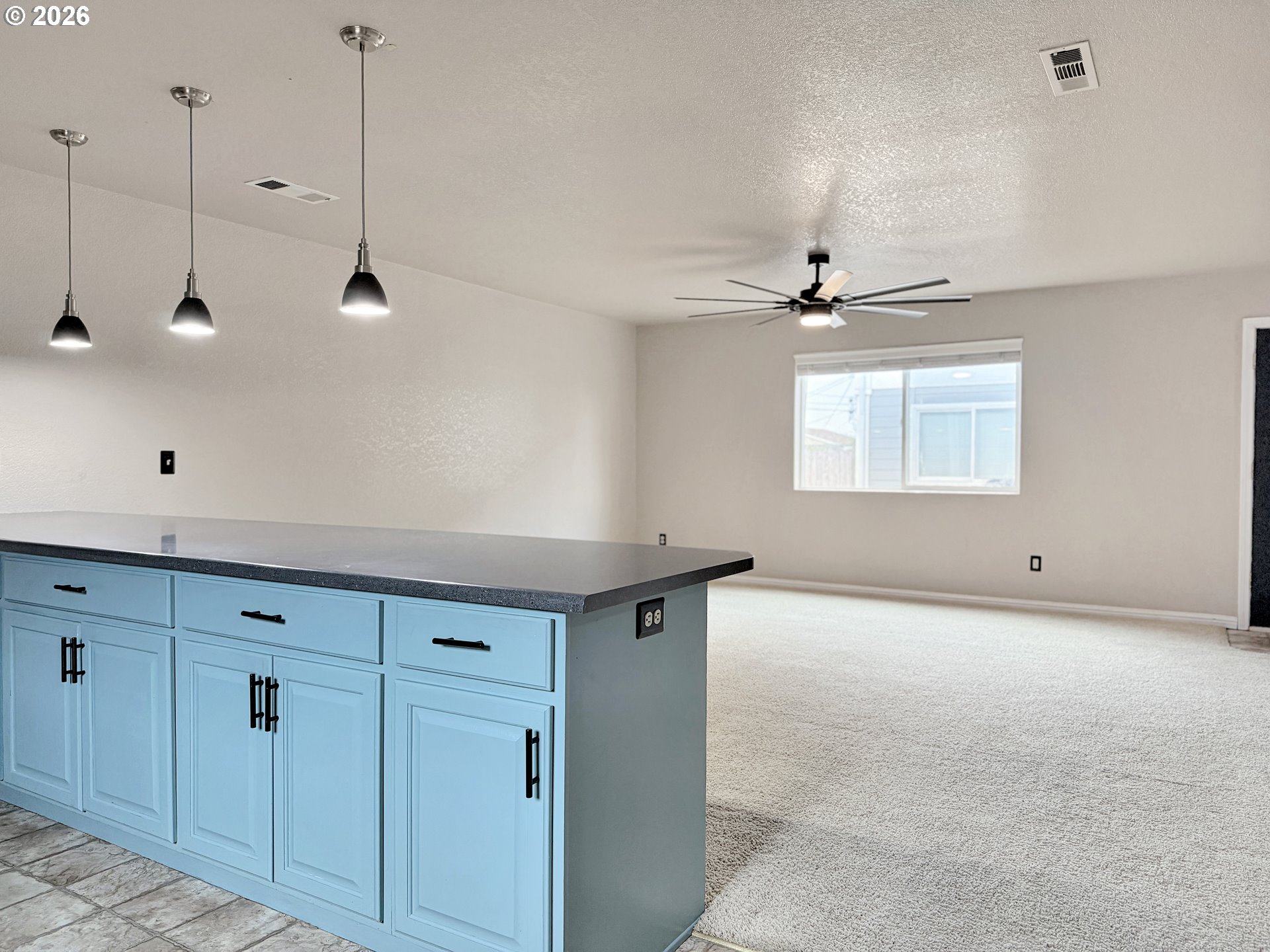 325 Matot Street, Unit B Brookings, OR 97415 - Photo 10 of 28 a view of a room with cabinet a ceiling fan and windows