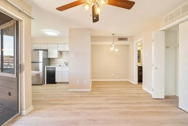 a view of a kitchen with wooden floor