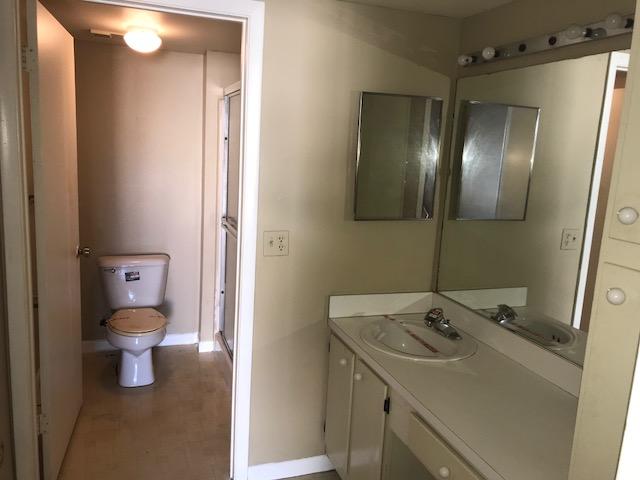 21950 Soundview Terrace, Unit 209 Boca Raton, FL 33433 - Photo 14 of 15 a bathroom with a sink toilet and vanity