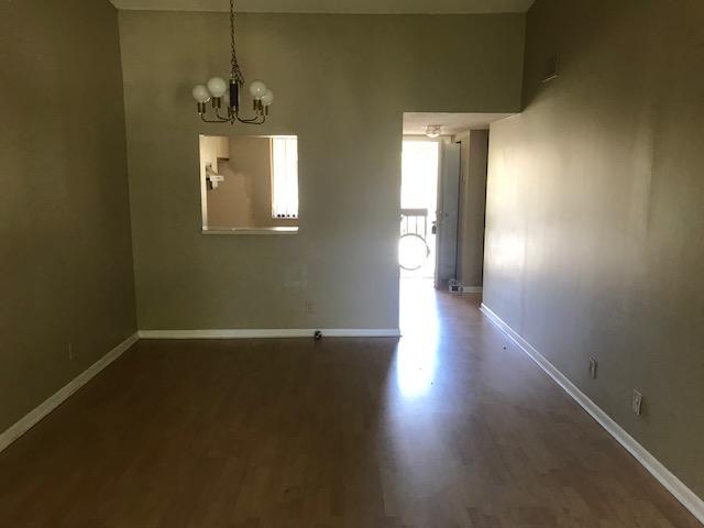 21950 Soundview Terrace, Unit 209 Boca Raton, FL 33433 - Photo 3 of 15 an empty room with wooden floor and windows