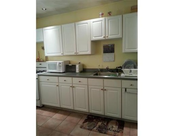 3 Gardner Street, Unit 2 Boston, MA 02132 - Photo 1 of 6 a kitchen with cabinets appliances and a sink
