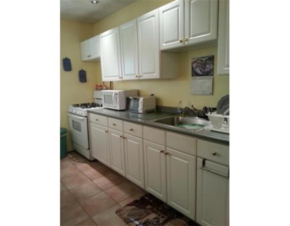 3 Gardner Street, Unit 2 Boston, MA 02132 - Photo 2 of 6 a kitchen with stainless steel appliances granite countertop a sink and cabinets