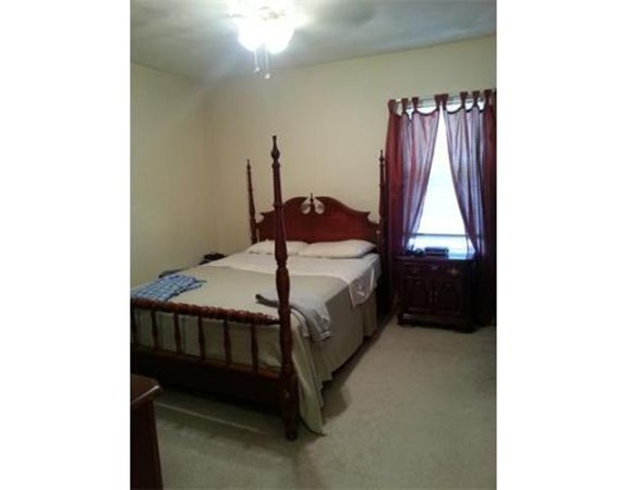 3 Gardner Street, Unit 2 Boston, MA 02132 - Photo 5 of 6 a bedroom with a bed and a closet