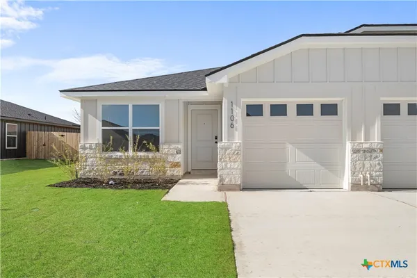 a front view of a house with a yard and porch