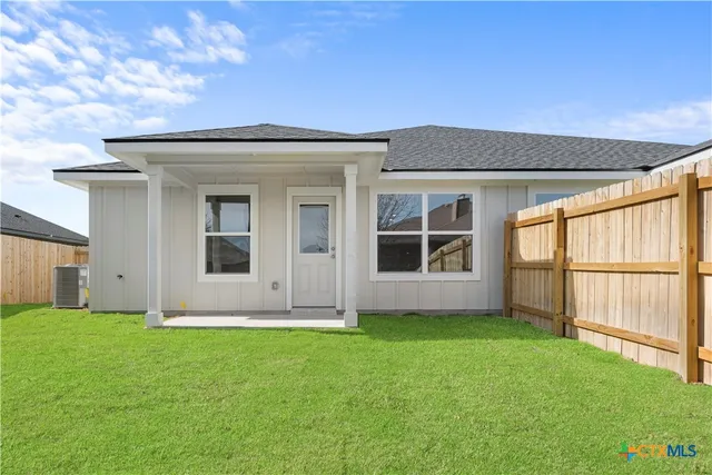a large white kitchen with wooden floor