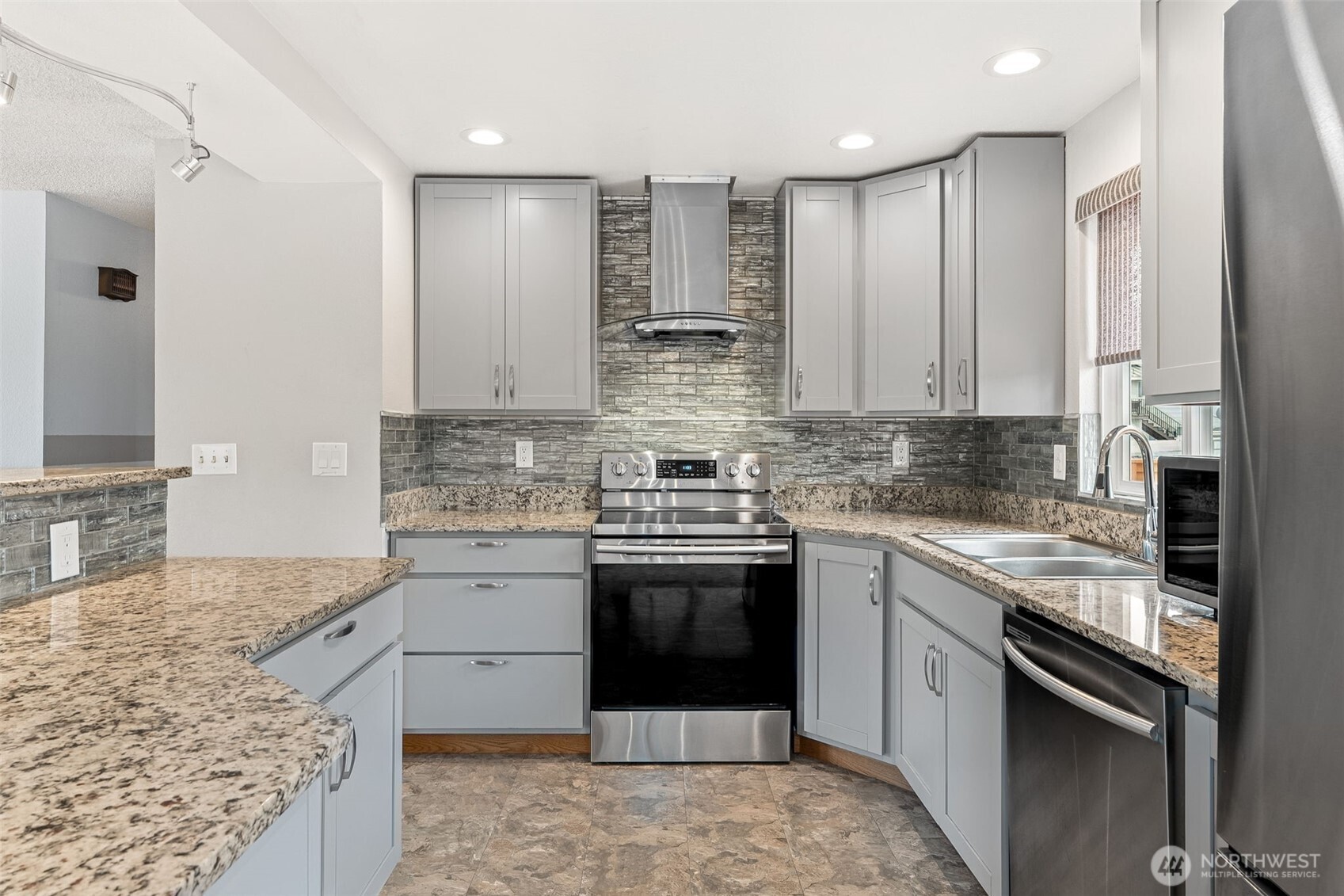 10014 108th Avenue Southwest Tacoma, WA 98498 - Photo 11 of 39 a kitchen with stainless steel appliances granite countertop a stove sink and cabinets