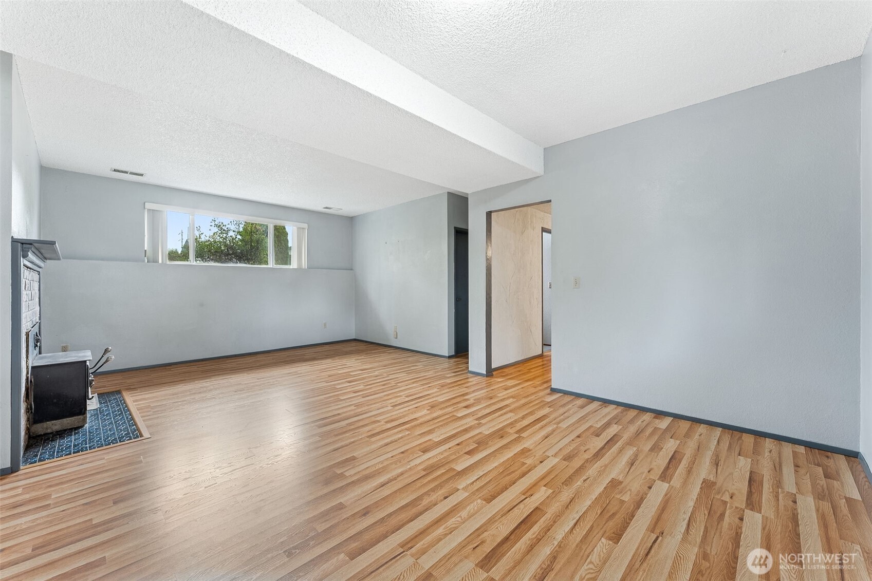 10014 108th Avenue Southwest Tacoma, WA 98498 - Photo 18 of 39 a view of an empty room with wooden floor and a window