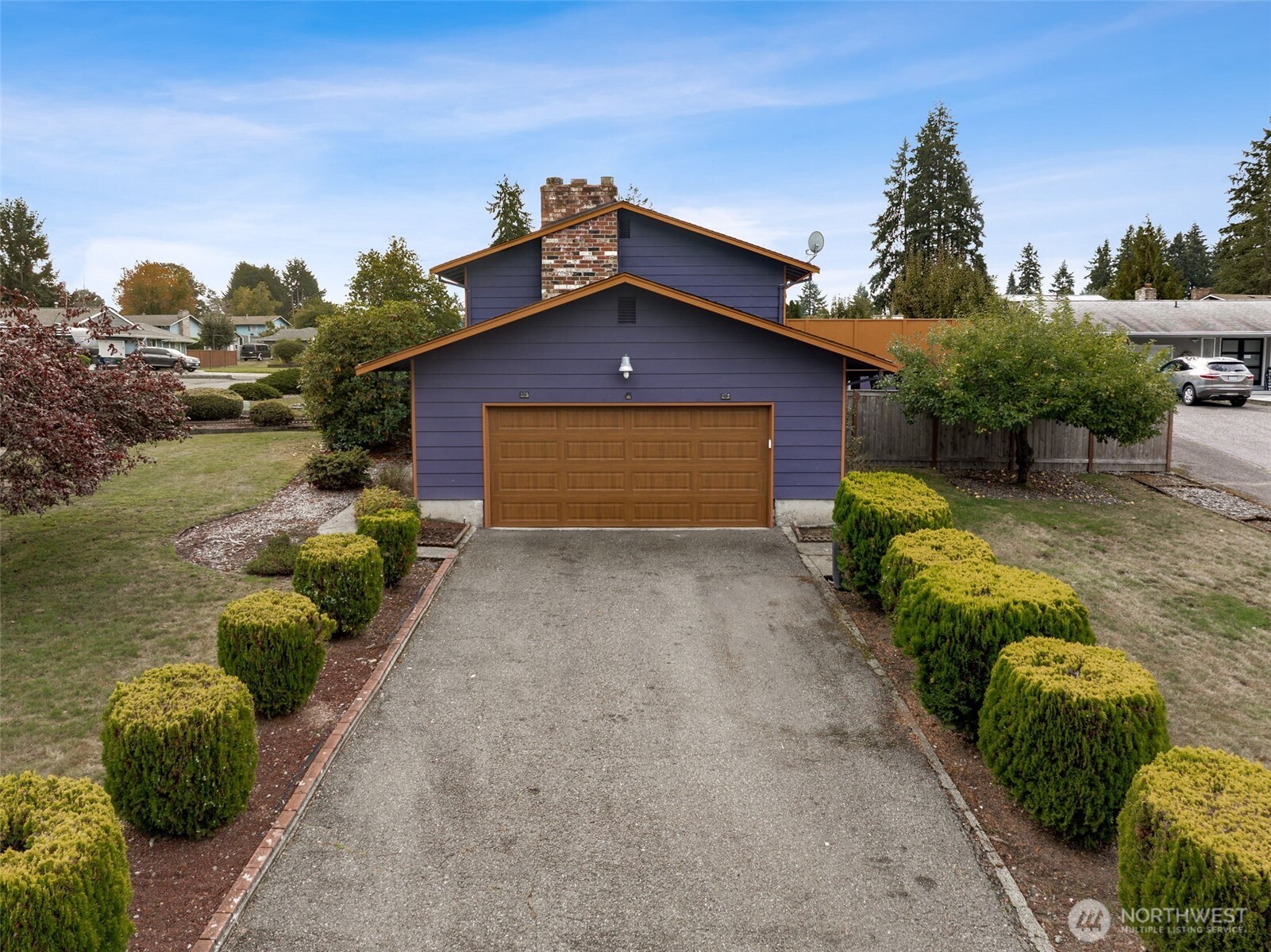 10014 108th Avenue Southwest Tacoma, WA 98498 - Photo 5 of 39 a front view of a house with a yard and garage