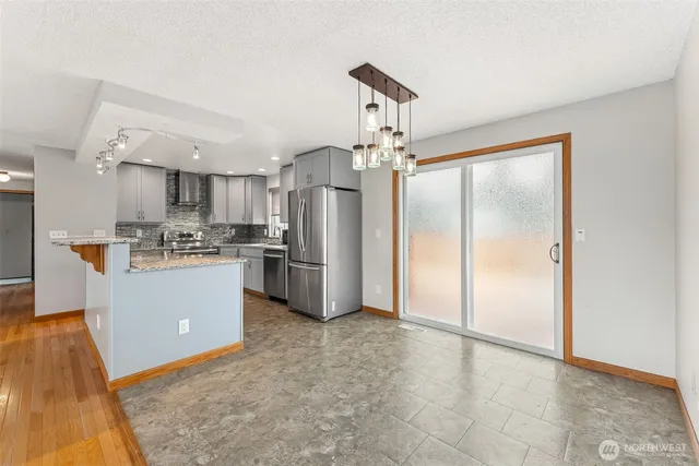 a kitchen with a refrigerator a sink and a stove top oven
