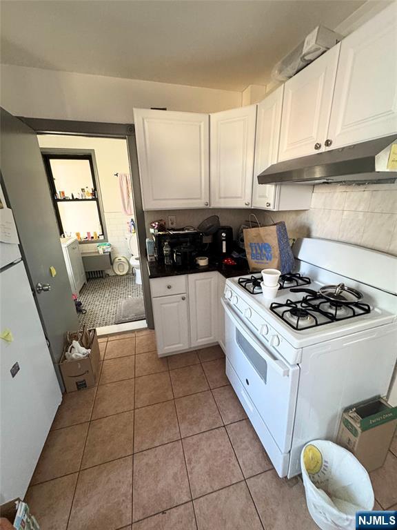 72 Lawrence Street Hackensack, NJ 07601 - Photo 11 of 11 a kitchen with a stove a sink and a refrigerator