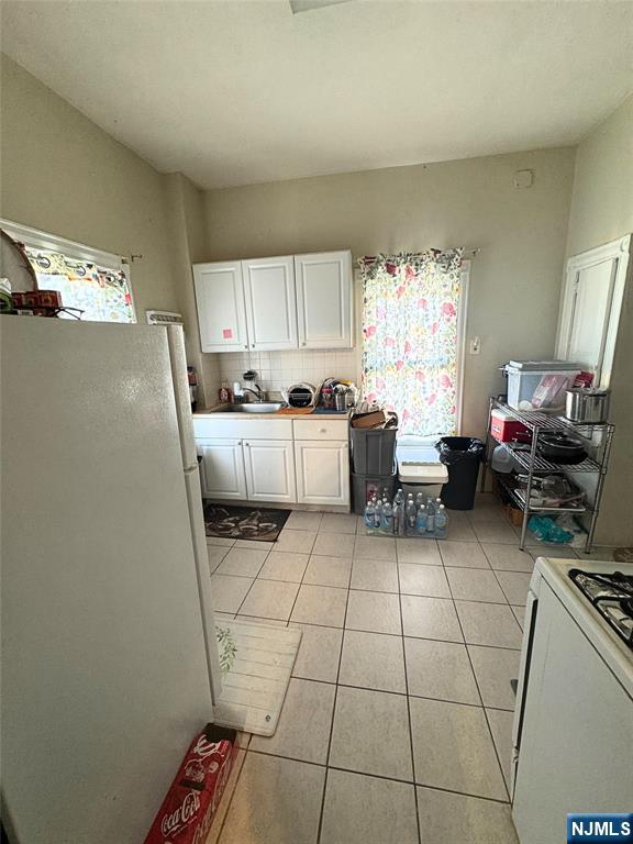 72 Lawrence Street Hackensack, NJ 07601 - Photo 6 of 11 a kitchen with a sink a window and cabinets