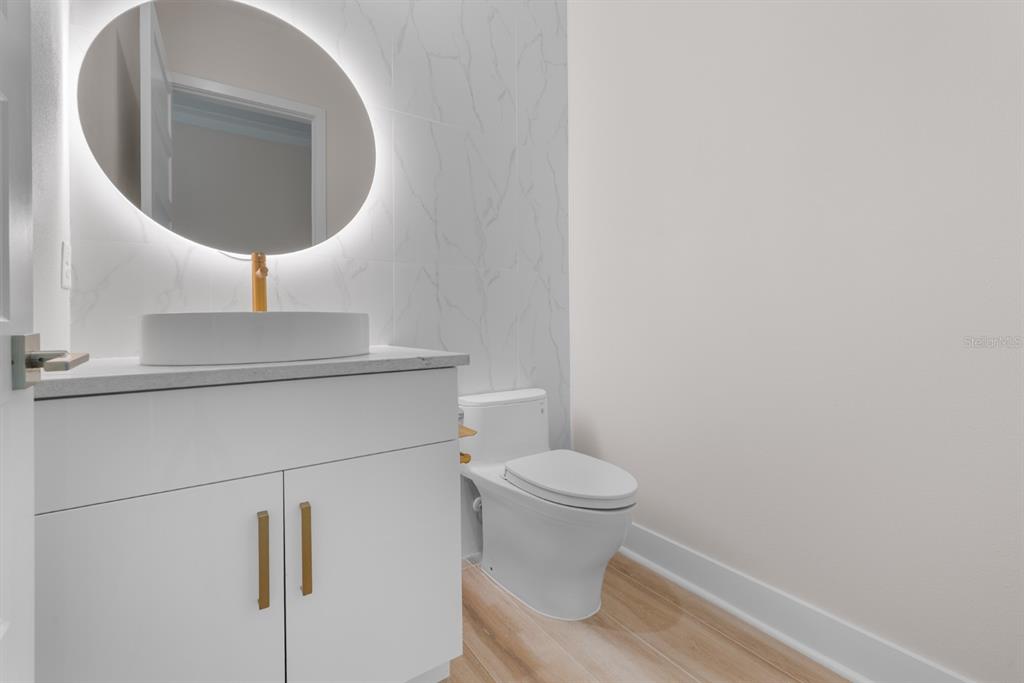 775 Gran Kaymen Way Apollo Beach, FL 33572 - Photo 14 of 43 a bathroom with a toilet and a sink