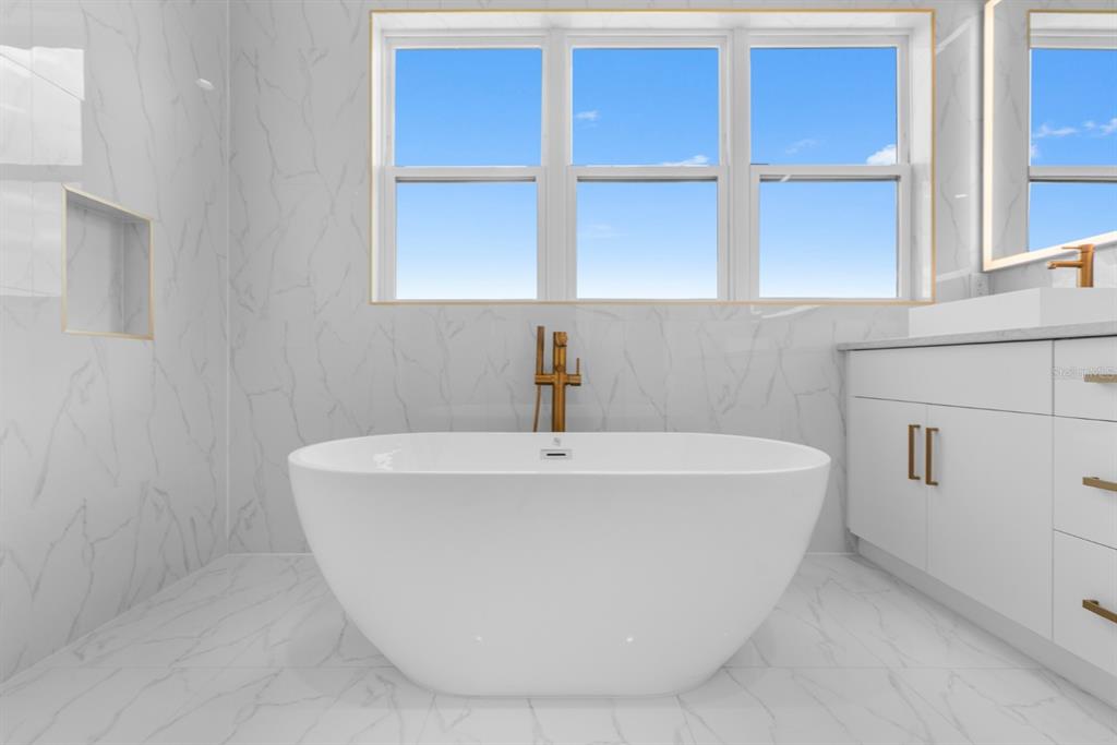 775 Gran Kaymen Way Apollo Beach, FL 33572 - Photo 20 of 43 a white bath tub sitting in a bathroom